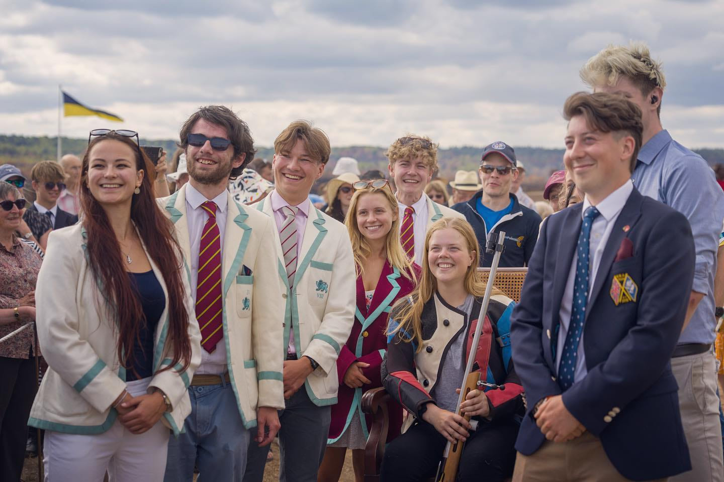 CURA members in club blazers around Alice Good in the winner’s chair after she won HM The Queen’s Prize at Bisley in 2022