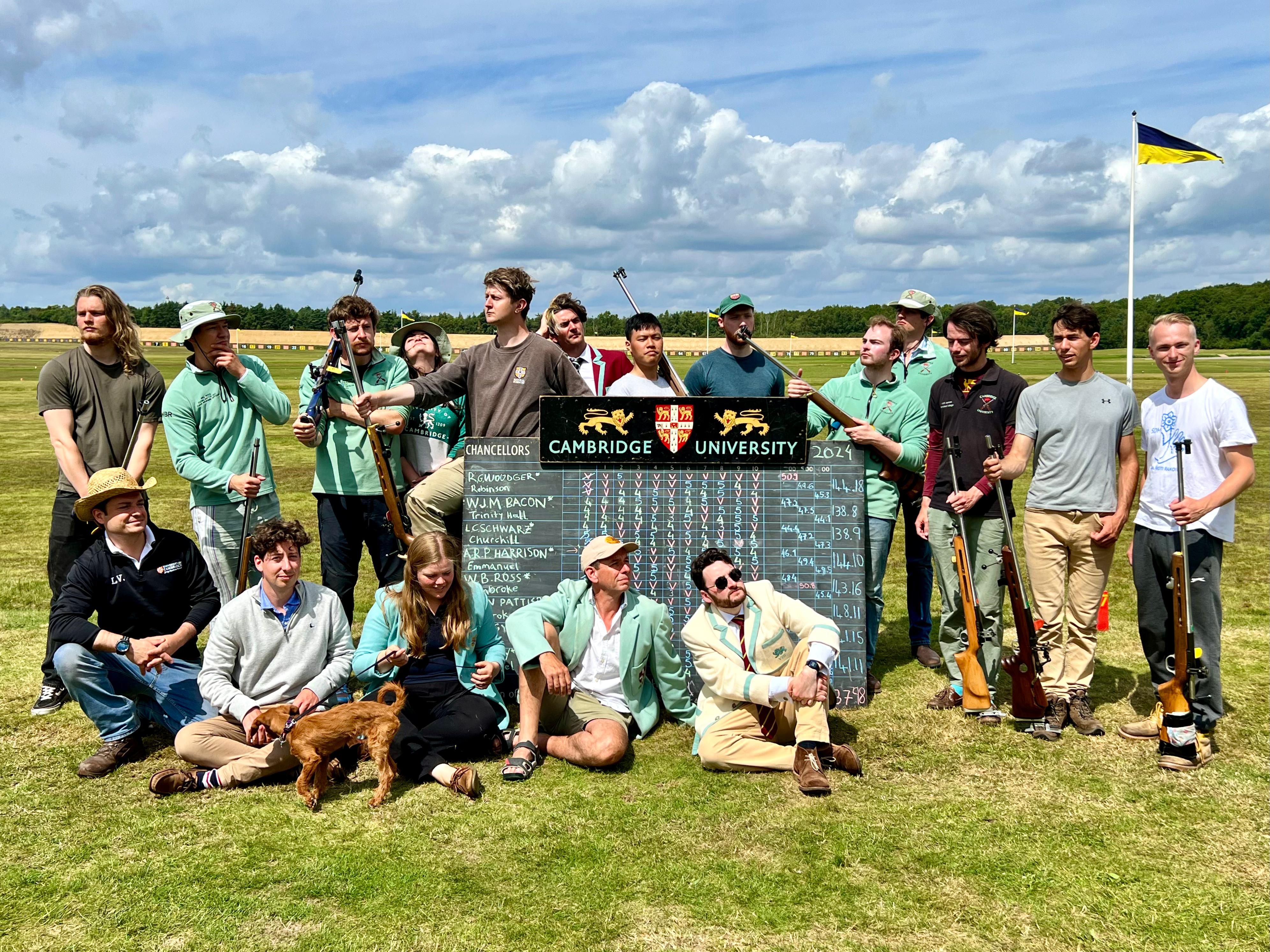 The Cambridge Chancellors’ team with the Varsity result board