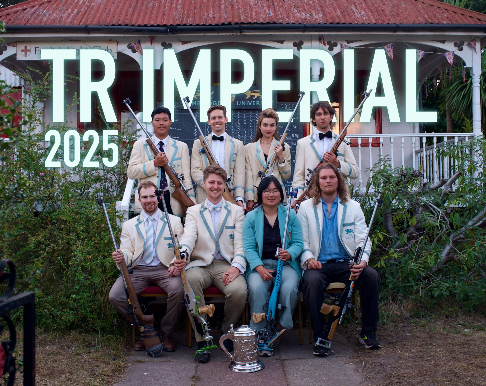 The 2025 Target Rifle squad in club blazers with their rifles and a trophy outside the English Eight Club