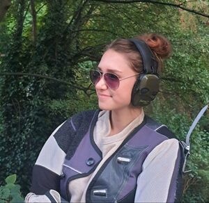 Adrienne Meagher in a shooting jacket and ear defenders on the range